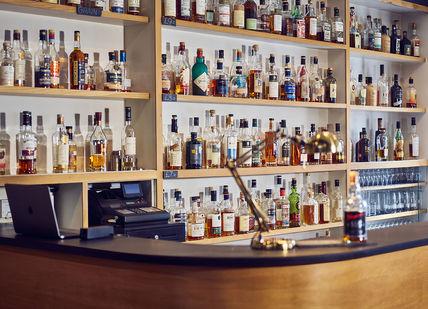 An image of a bar with bottles of alcohol, Soho Whisky Club. Soho Whisky Club