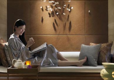 An image of a woman reading a book, Tea and Therapy. The Spa at Mandarin Oriental