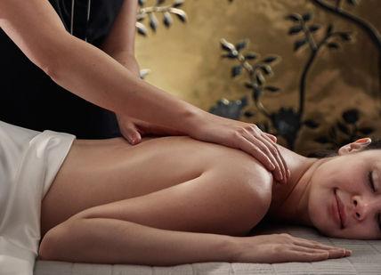 An image of a woman getting a massage, Water Wellness. The Spa at Mandarin Oriental