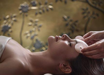 An image of a woman getting a facial massage, Water Wellness. The Spa at Mandarin Oriental