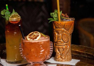 An image of two drinks on a table, Tiki Classics Masterclass With A Meal. Sugar Cane Bar