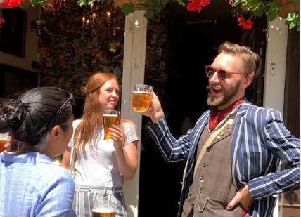 An image of a man and woman drinking beer, London Bike Tour. Tally Ho