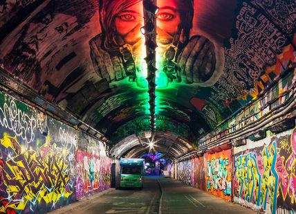 An image of a tunnel with graffiti on the walls, London Bike Tour. Tally Ho