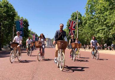An image of people riding bikes down the street, London Bike Tour. Tally Ho