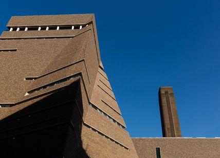 An image of a building with a clock on the top, Private Tate Modern Tour & Lunch. Tate Modern