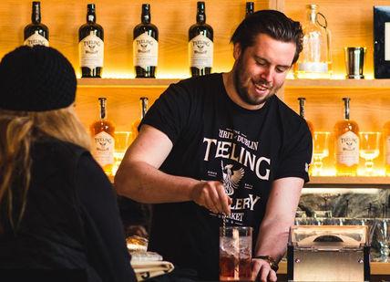An image of a bartender at a bar, Tasting of single malt whiskies. Teeling Whiskey Distillery