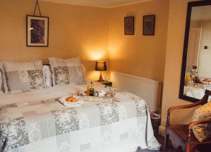 An image of a bedroom with a bed and a chair, Two-night stay in the Shepherd's Hut OR Double Bedroom with Private Bathroom (includes breakfast on both mornings and bottle of prosecco). Townsend Farm