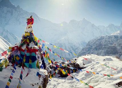 An image of a mountain with prayer flags, 7-Day Everest Base Camp Trekking And Helicopter Trip. Trekking Guide Team Adventure