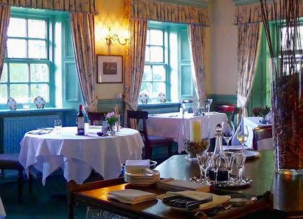 An image of a restaurant setting with tables and chairs, Welsh Gourmet Getaway. Tyddyn Llan