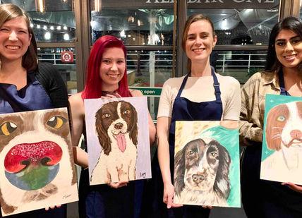 An image of three women holding paintings of dogs, Paint Your Pet Workshop. Undergrounder