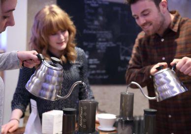 An image of a man and woman pouring coffee, Coffee Brewing Masterclass. Union Brew Lab