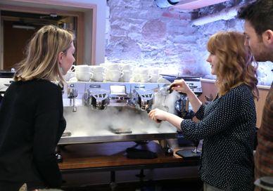 An image of a woman and man in a coffee shop, Espresso Masterclass. Union Brew Lab