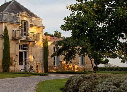 An image of a house in the evening, Bespoke Group Bordeaux Wine Making. VINIV