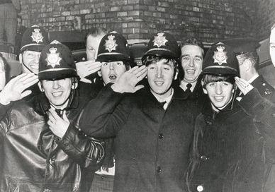 An image of a group of people in uniform, Private Beatles Walking Tour. Who Knew Tours