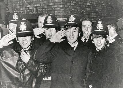 An image of a group of people in uniform, Private Beatles Walking Tour. Who Knew Tours