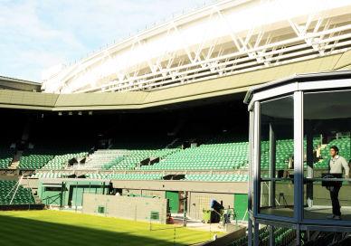 An image of a tennis court with a man on the court, Private guided Wimbledon tour. Wimbledon