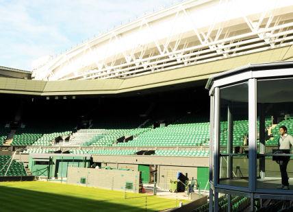 An image of a tennis court with a man on the court, Private guided Wimbledon tour. Wimbledon