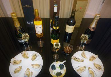 An image of a table with wine and food, Introductory Caviar, Champagne And Wine Tasting. Wine Cottage