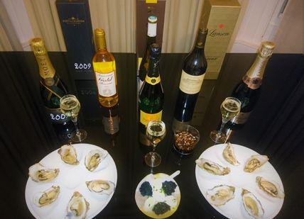 An image of a table with wine and food, Introductory Caviar, Champagne And Wine Tasting. Wine Cottage