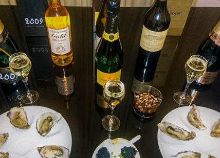 An image of a table with wine and food, Premium Caviar, Champagne & Wine Tasting. Wine Cottage
