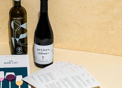 An image of a wine bottle and menus, Three-Month Virtual Wine Course. The Wine List