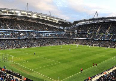 An image of a soccer stadium with a large crowd, The Champion Manchester City Football Experience. Wonderment Entertainment
