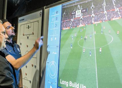 An image of a soccer game on a tv screen, Private Group Manchester City Football Experience. Wonderment Entertainment