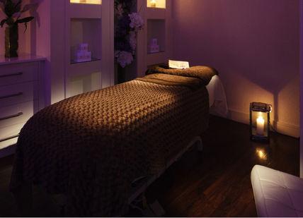 An image of a bedroom with a bed and a night light, Hot Stone Massage. Zen Lifestyle Bruntsfield Place