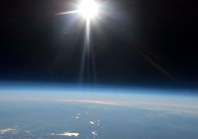 An image of the sun shining over the earth, Private Group Space Travel with Bloon. Zero2Infinity