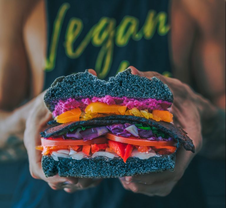 Vegan holding a plant-based burger