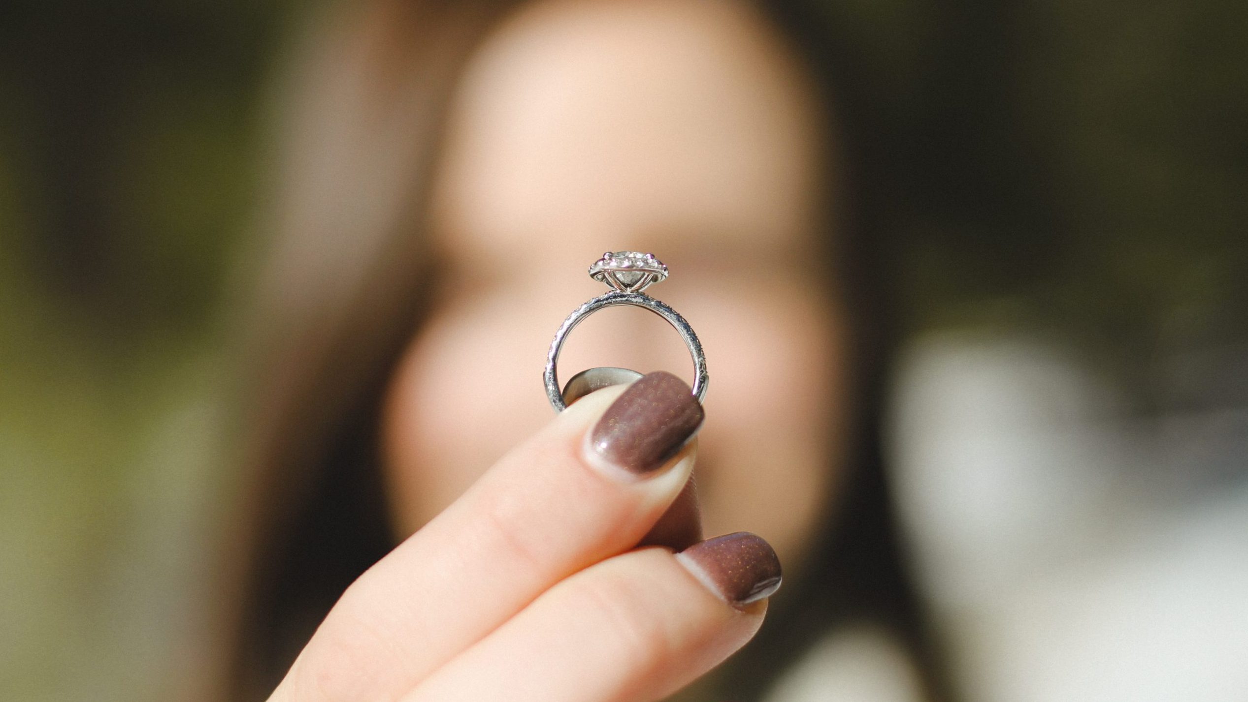 Bride holds diamond wedding ring