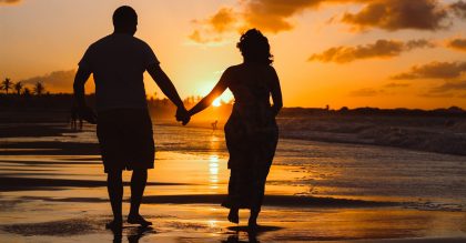 Couple walking on beach for 35th wedding anniversary