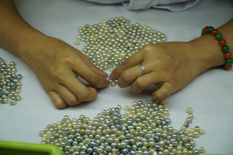 Woman handling real raw pearls