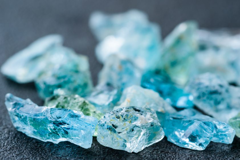 Collection of lovely blue uncut aquamarine gemstones.
