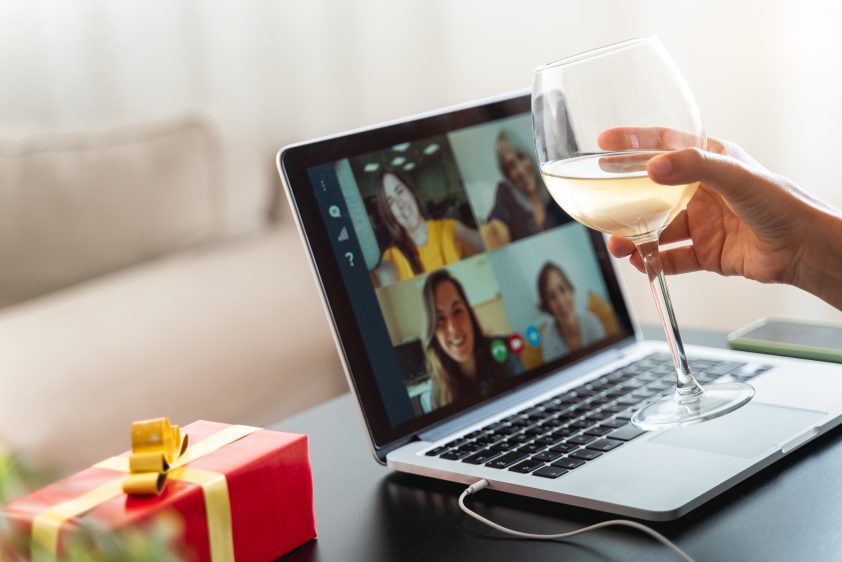 Happy woman toasting and celebrating Christmas online in quarantine time during coronavirus outbreak