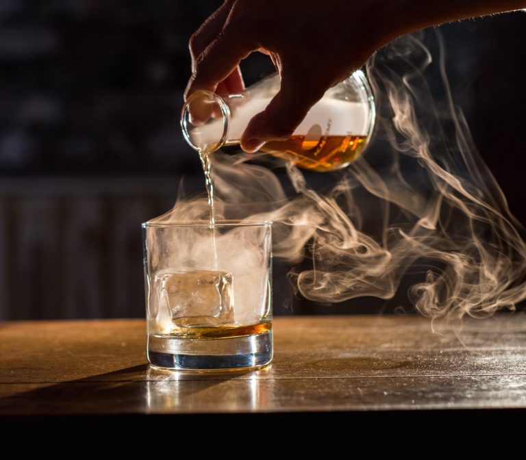 Premium whisky being poured over ice at Bull in a China Shop