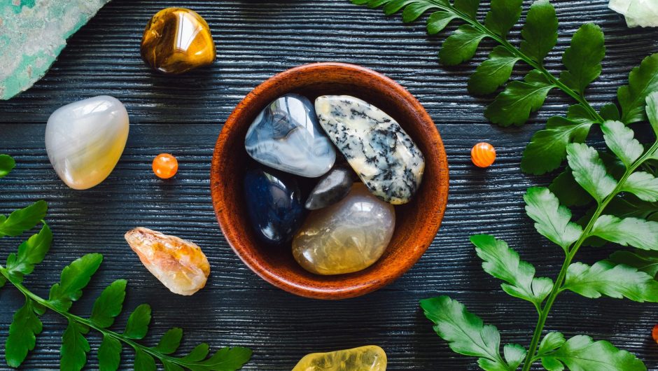 Bowl of Agate and Zodiac Stones of Gemini; Chalcedony, Agate, Citrine, Apophyliite, Tiger's Eye, Chrysocolla and Serpentine on Blue Background