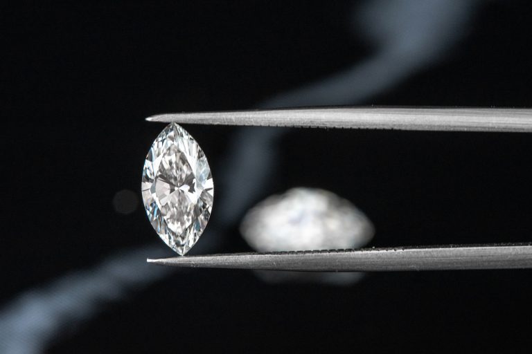marquise diamond with tweezer on black background