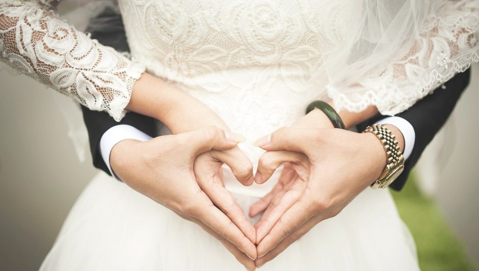 bride and groom hands forming heart shaped