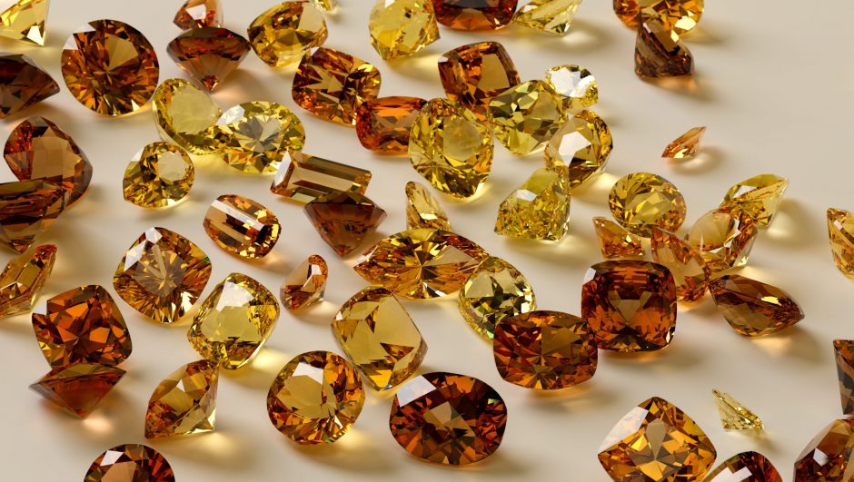 Colorful yellow, orange, brown gemstones on white background