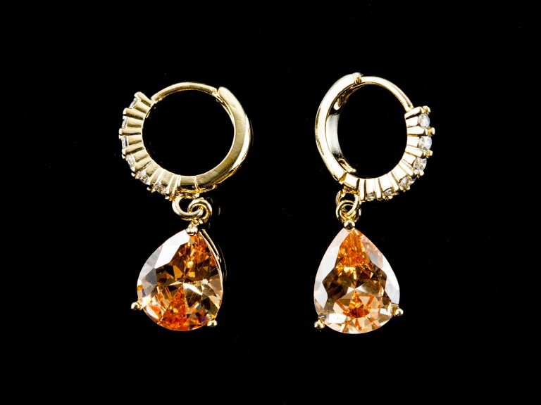 Orange diamond earings isolated on black