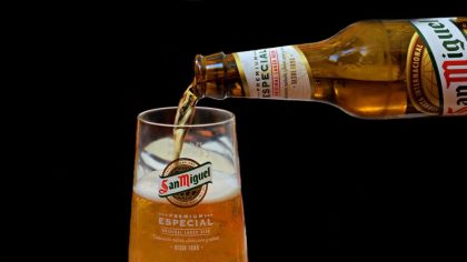 glass of beer and bottle of famous Spanish San Miguel beer on a