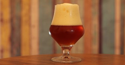 Belgian craft beer glass with amber dubbel ale