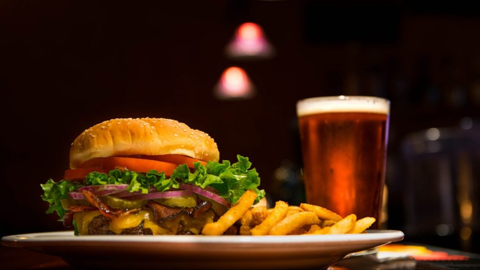 cold saison beer and grilled burger patty with fries