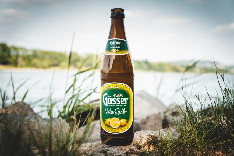 enjoying a bottle of Gösser Natur Radler beer at the Rhine river in Bonn, Germany